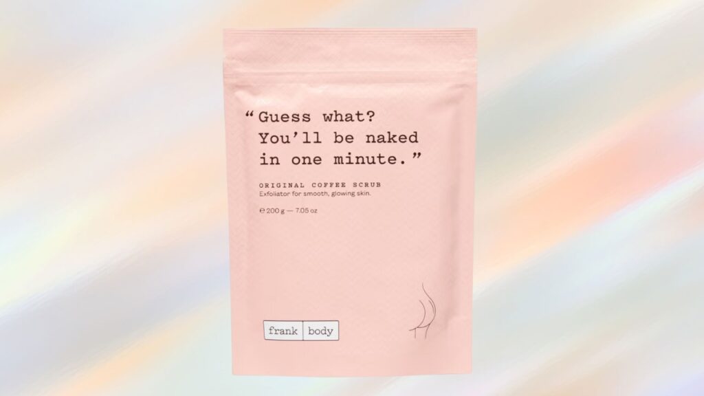 Frank Body Original Coffee Scrub in a pink pouch, labeled as an exfoliator for smooth, glowing skin with natural ingredients like coffee and sea salt.