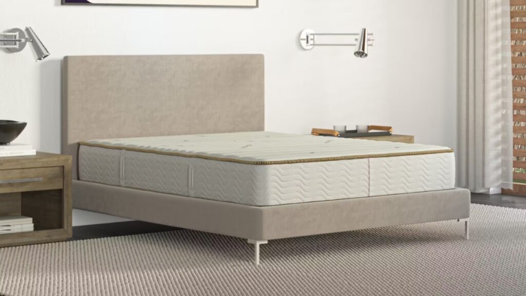 Saatva mattress in a simple modern bedroom with soft lighting and neutral tones.