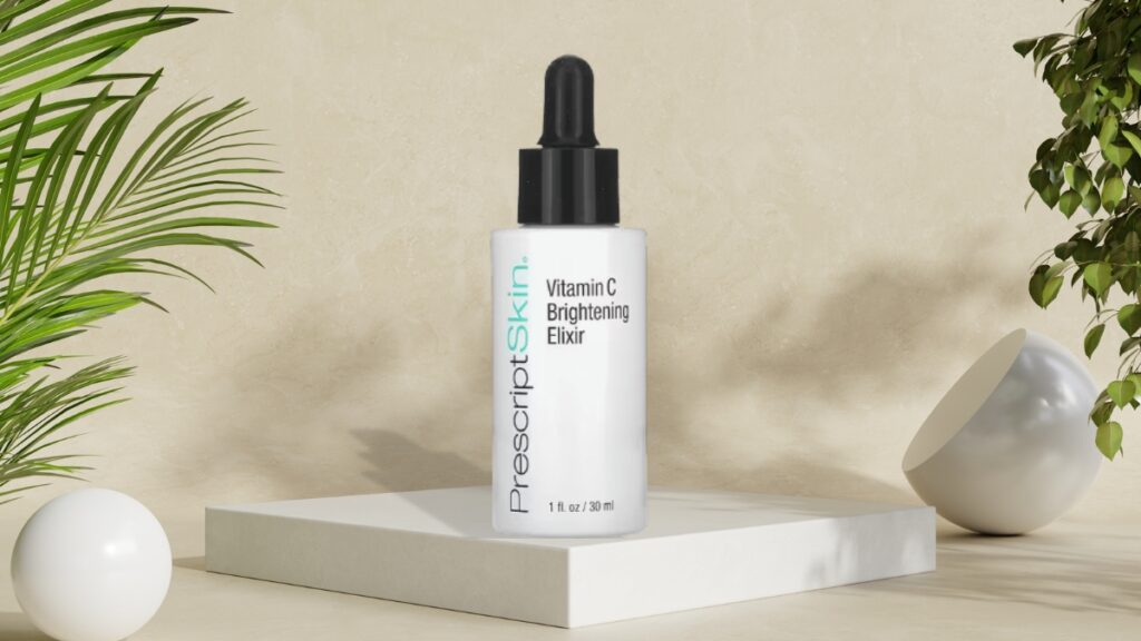 PrescriptSkin Vitamin C Brightening Elixir in a 30ml dropper bottle displayed on a white stand, a skincare product used to even out skin tone.