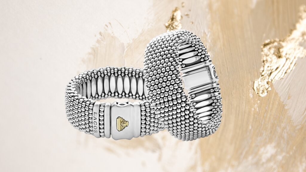 Two wide sterling silver Lagos Caviar bracelets with textured beading and gold-accented clasps shown against a soft gold-toned background.