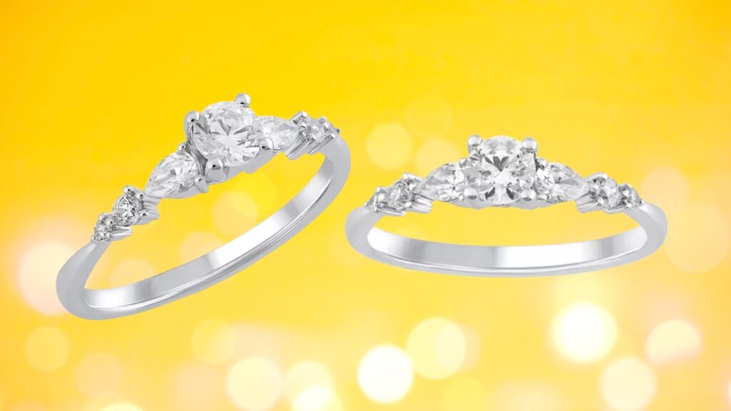 A white gold engagement ring with a round center diamond and pear-shaped side stones shown from two angles on a yellow background.