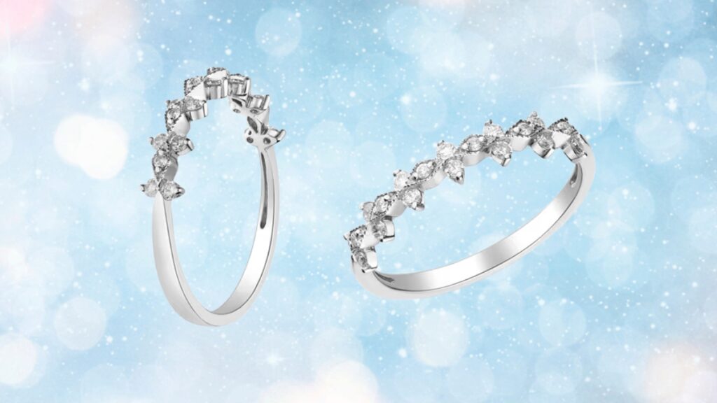 A white gold engagement ring with round and baguette diamonds in a floral-inspired setting shown from two angles.